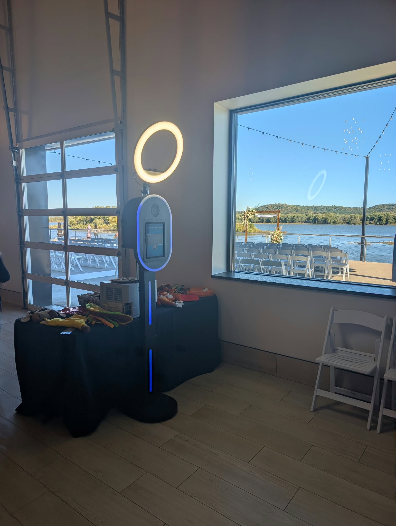 Absolute Music photo booth with ring light and props beside a river-facing window