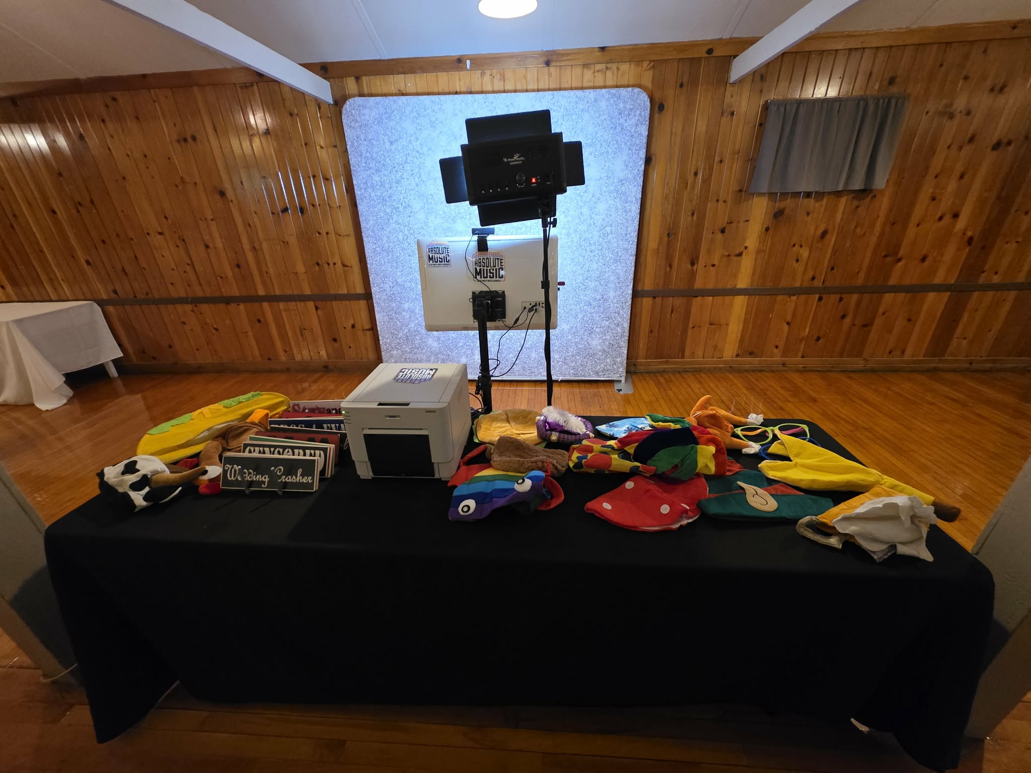 Absolute Music photo booth camera, silver backdrop and colorful props table