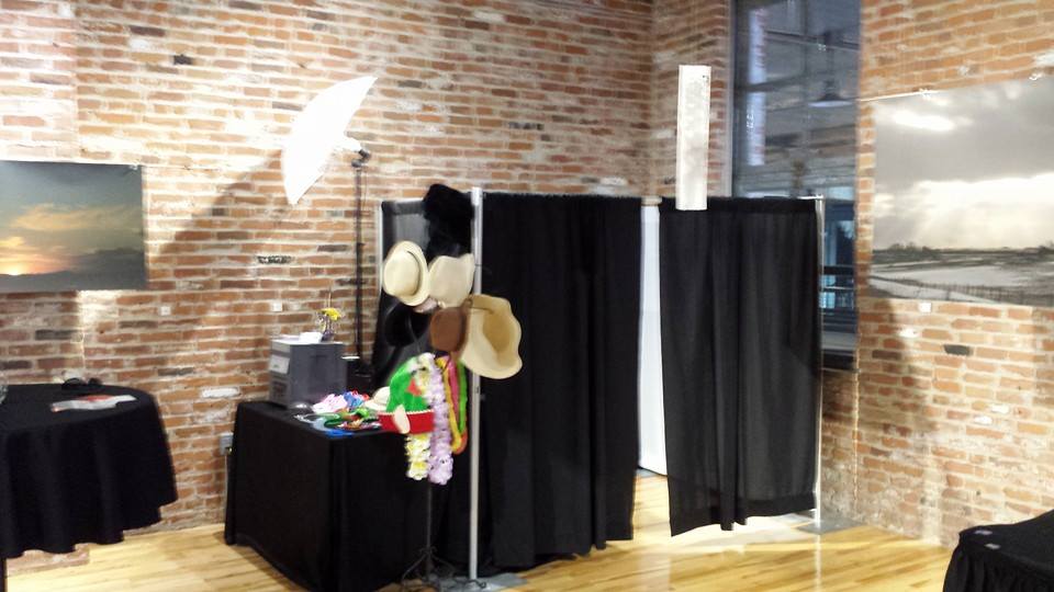 Absolute Music enclosed photo booth and props beside exposed brick walls
