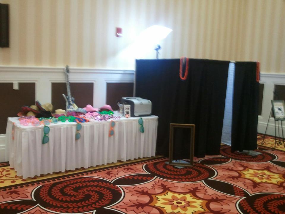 Absolute Music enclosed photo booth with props table and umbrella light